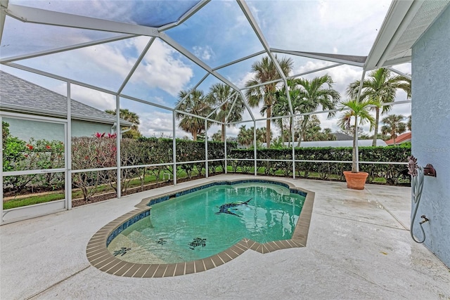 view of swimming pool featuring a lanai, fence, a fenced in pool, and a patio