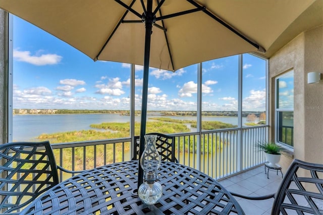 sunroom / solarium featuring a water view