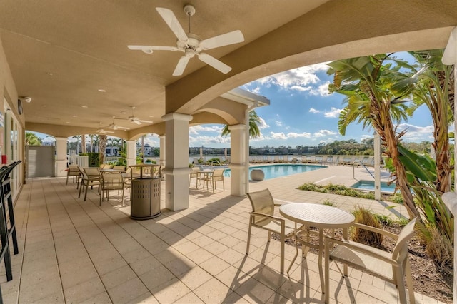 view of patio featuring a ceiling fan and a community pool