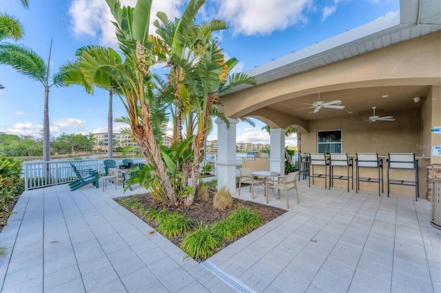 view of patio / terrace with outdoor dining space, fence, and a ceiling fan