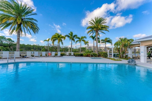 community pool featuring a patio area and fence