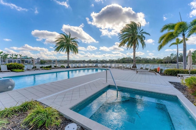 pool featuring fence and a patio