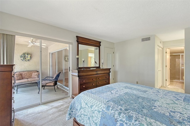 bedroom featuring a closet, visible vents, light carpet, and a textured ceiling