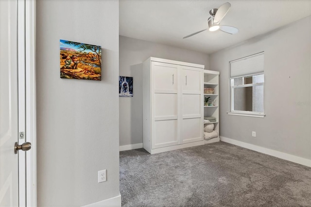 unfurnished bedroom with carpet floors, a ceiling fan, and baseboards