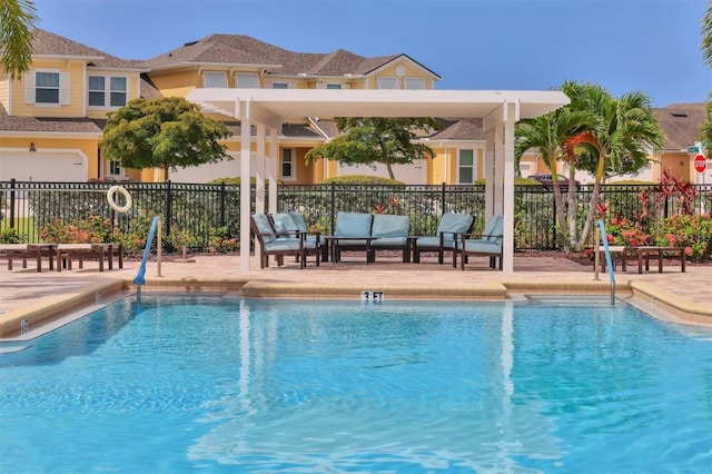 pool featuring fence, an outdoor living space, and a patio