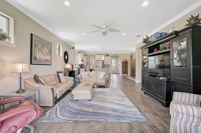 living room featuring dark wood-style floors, recessed lighting, and crown molding