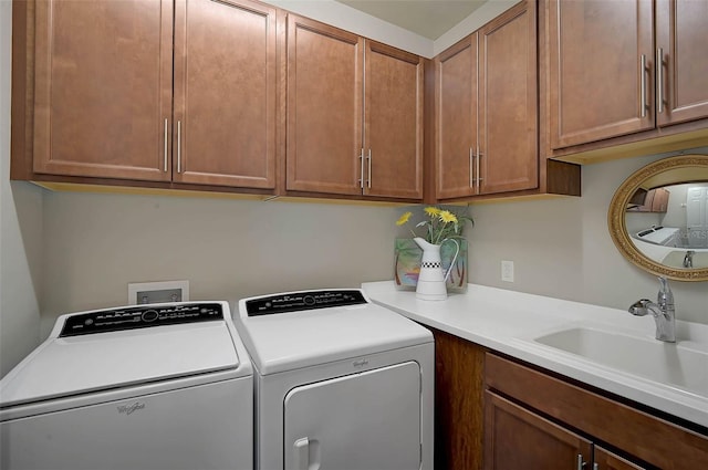 laundry area featuring a sink, cabinet space, and washer and dryer