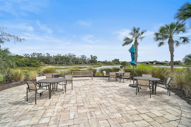 view of patio / terrace with a water view and outdoor dining area