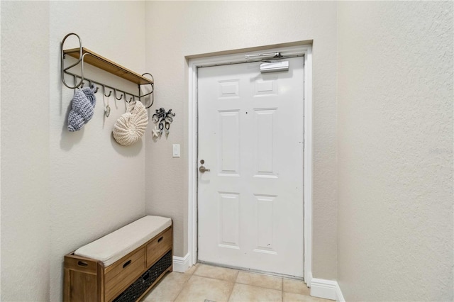 mudroom featuring baseboards and light tile patterned flooring