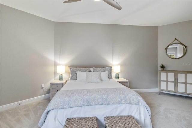 carpeted bedroom featuring ceiling fan and baseboards