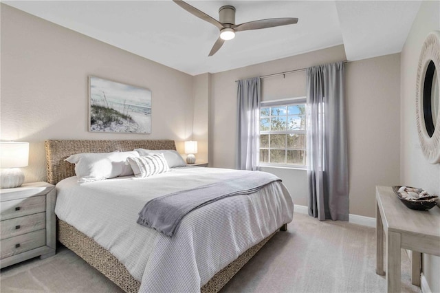 bedroom featuring ceiling fan, baseboards, and light colored carpet