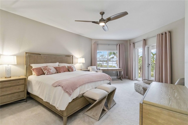 bedroom featuring light carpet, access to outside, and a ceiling fan