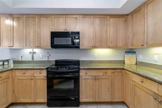 kitchen with black appliances and dark stone countertops