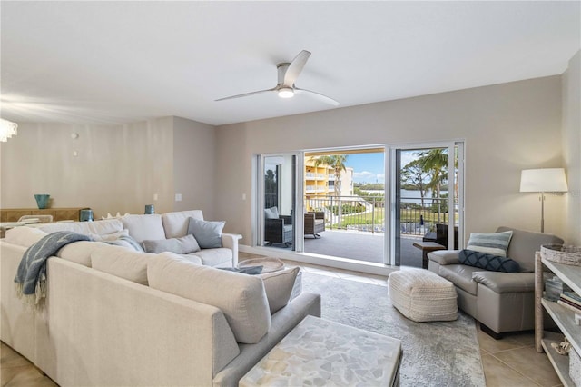 living room with ceiling fan with notable chandelier and light tile patterned floors