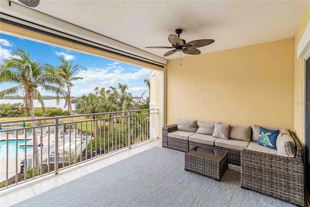 balcony with outdoor lounge area and a ceiling fan