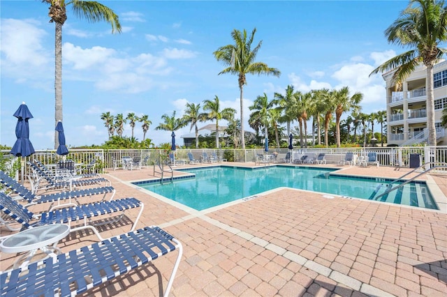 community pool featuring a patio area and fence