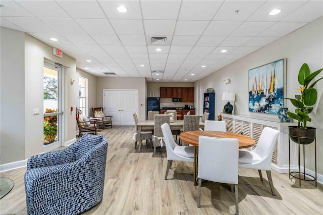 dining area featuring a paneled ceiling, recessed lighting, visible vents, baseboards, and light wood-style floors