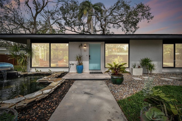 doorway to property with stucco siding