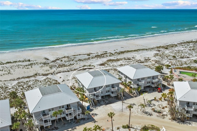 birds eye view of property with a beach view and a water view