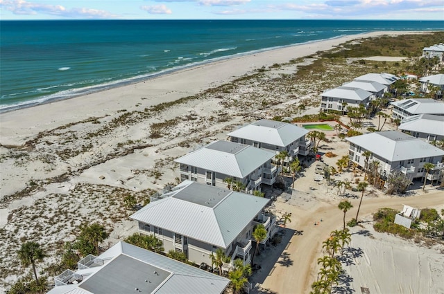 drone / aerial view with a beach view, a residential view, and a water view