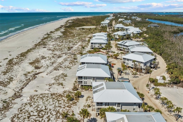 bird's eye view featuring a water view, a residential view, and a view of the beach