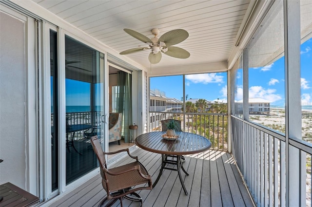 sunroom / solarium featuring ceiling fan