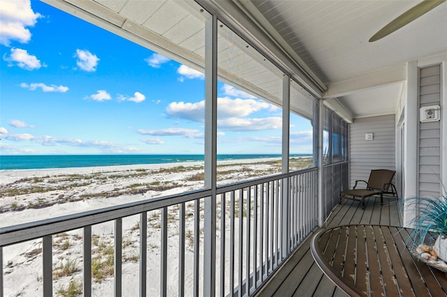 balcony with a water view and a beach view