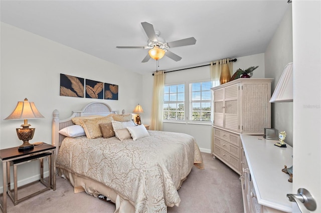 bedroom featuring baseboards, ceiling fan, and light colored carpet