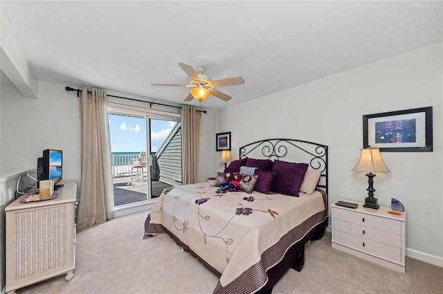 bedroom featuring light carpet, access to outside, and ceiling fan