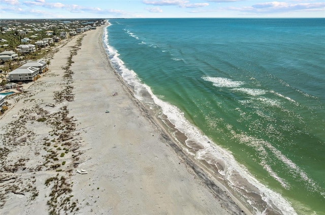 drone / aerial view with a water view and a beach view