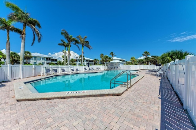 pool featuring a patio area and fence