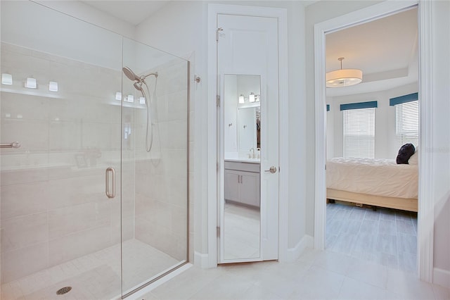 full bath with a stall shower, tile patterned flooring, vanity, and ensuite bathroom