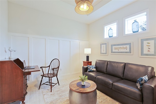 living room with a wainscoted wall and a decorative wall