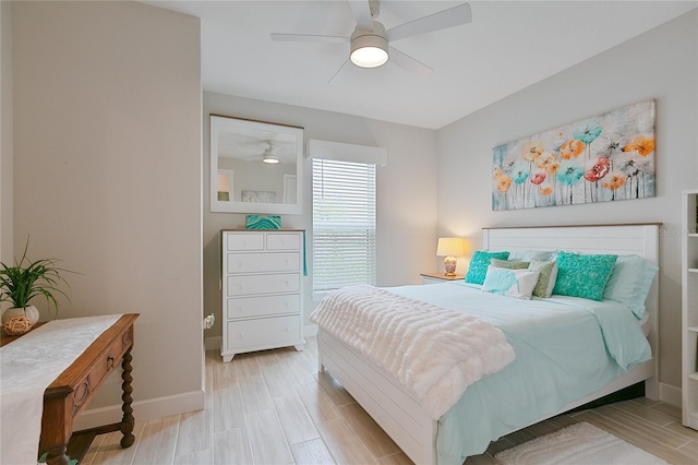 bedroom with wood tiled floor, baseboards, and ceiling fan