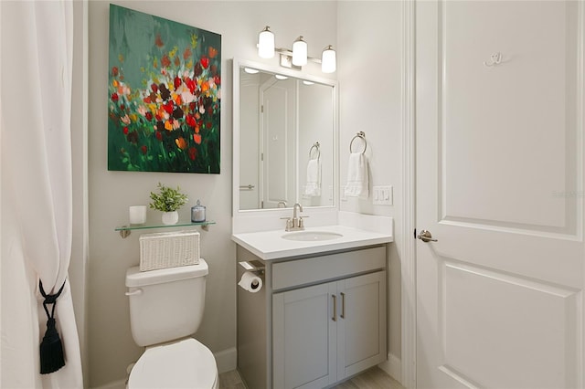 bathroom with toilet and vanity