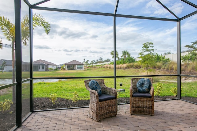 unfurnished sunroom with a water view