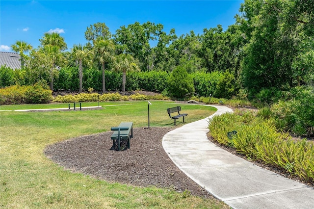 view of property's community with a lawn