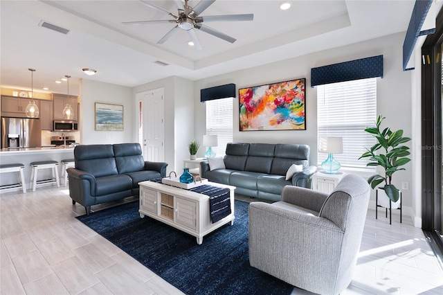 3008 Tolmino Ct, Lakewood Ranch, FL 34211 - living area with visible vents, recessed lighting, a tray ceiling, and a ceiling fan