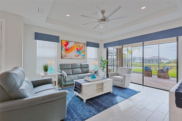 3008 Tolmino Ct, Lakewood Ranch, FL 34211 - living area featuring visible vents, a raised ceiling, a ceiling fan, and recessed lighting