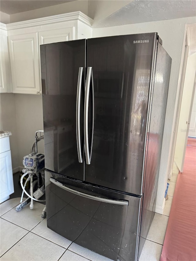 room details with light countertops, freestanding refrigerator, and white cabinetry