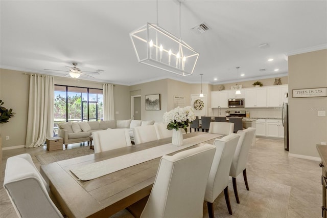 dining room with recessed lighting, baseboards, visible vents, crown molding, and ceiling fan with notable chandelier