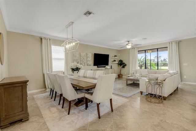 dining space with baseboards, ceiling fan with notable chandelier, visible vents, and crown molding