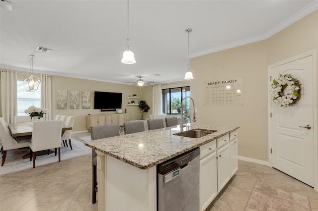 kitchen featuring hanging light fixtures, a kitchen island with sink, white cabinetry, a sink, and dishwasher