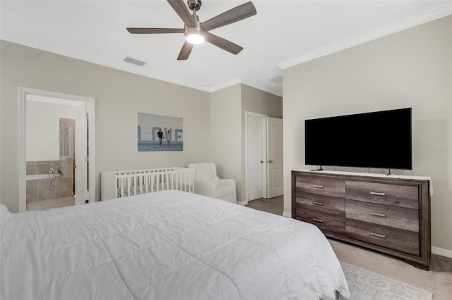 bedroom with crown molding, light colored carpet, visible vents, connected bathroom, and baseboards