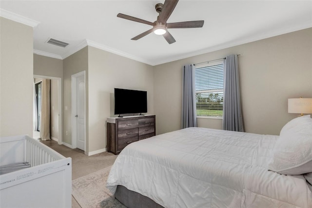 bedroom with light colored carpet, a ceiling fan, baseboards, visible vents, and crown molding