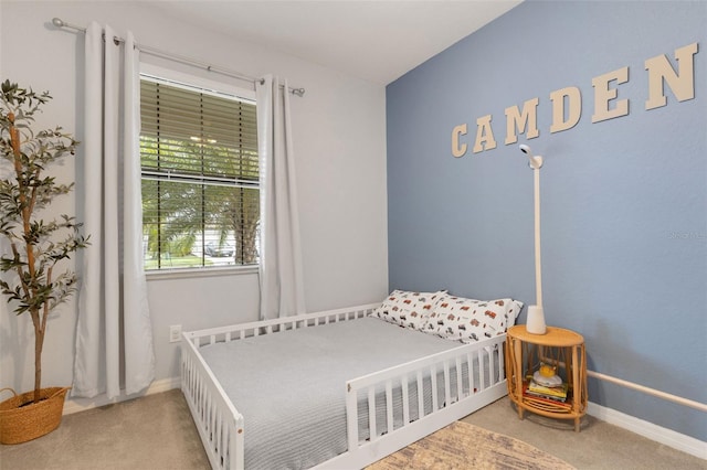 carpeted bedroom featuring baseboards