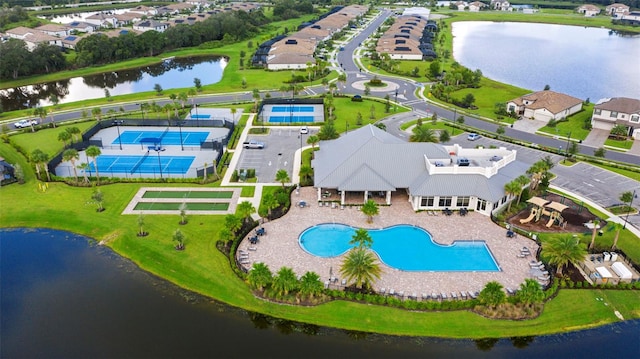 birds eye view of property with a water view and a residential view