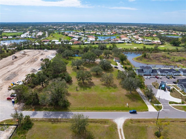 birds eye view of property featuring a water view and a residential view