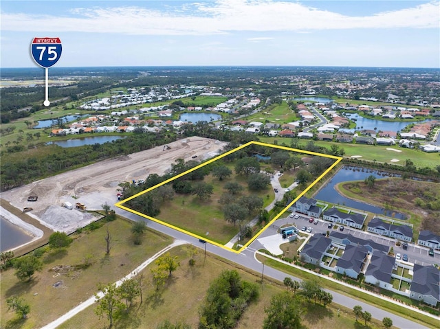 birds eye view of property featuring a residential view and a water view