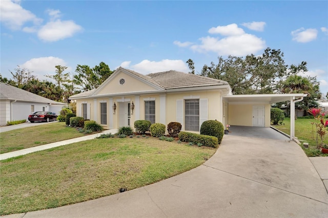 greek revival inspired property with driveway, a carport, a front lawn, and stucco siding